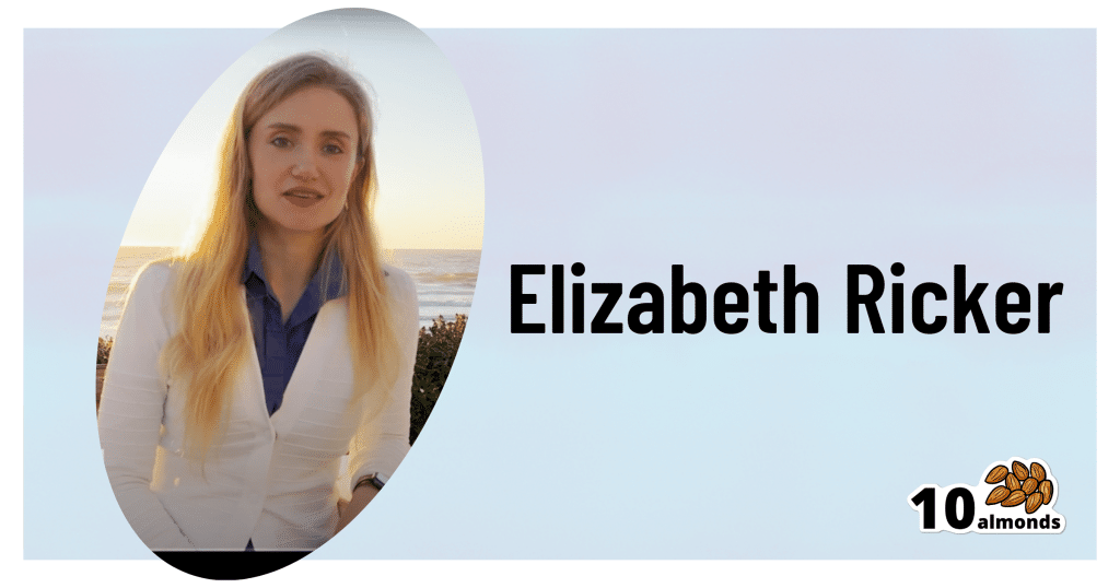 Elizabeth Ricker stands before the tranquil ocean, contemplating the vast expanse before her.